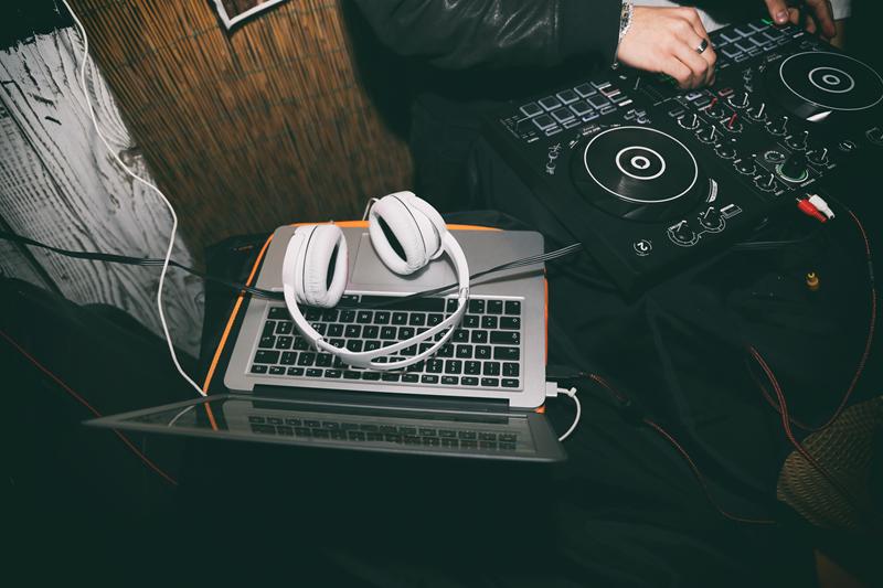 DJ equipment including laptop and headphones